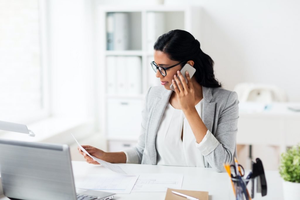 businesswoman calling on smartphone at office