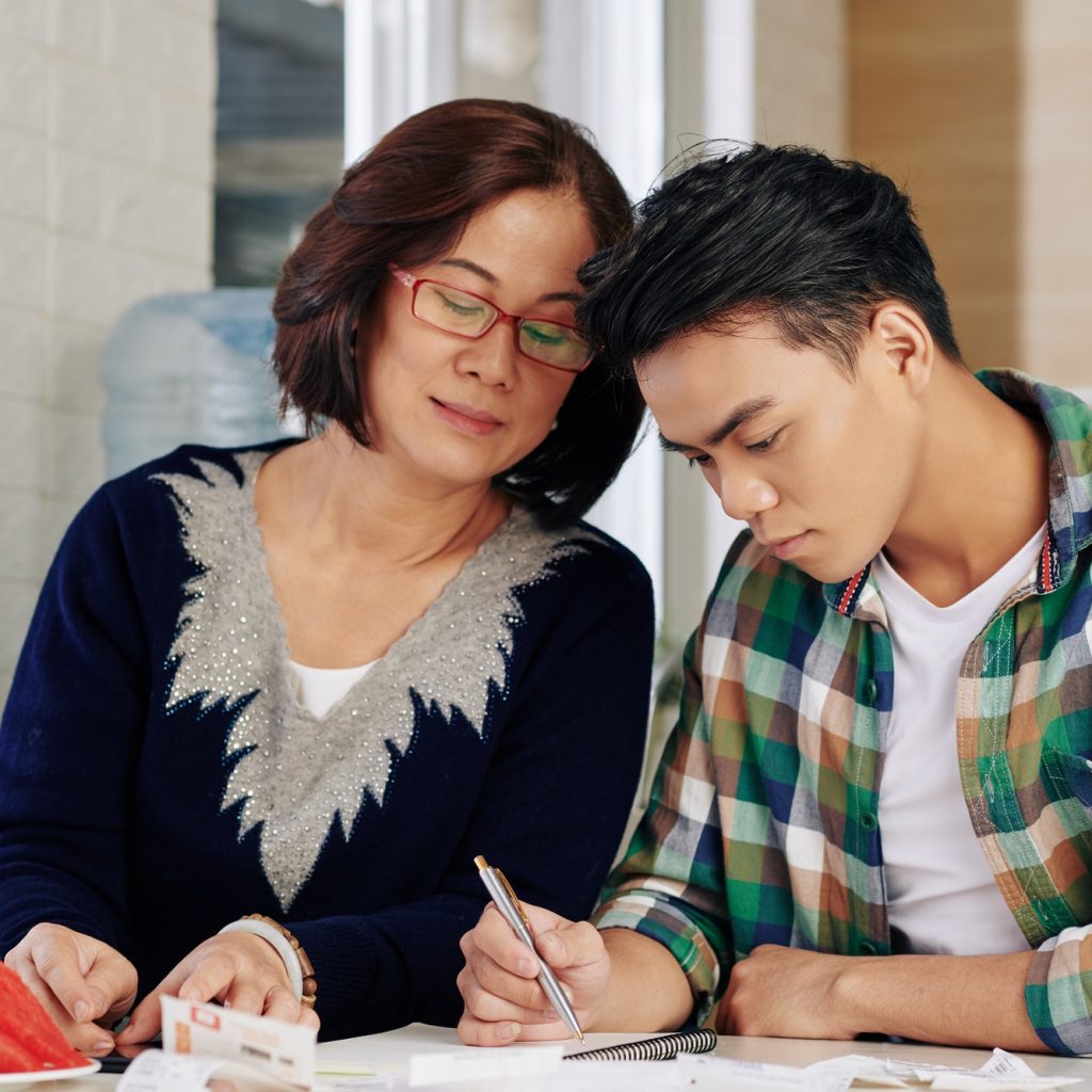 Mother and son checking bills